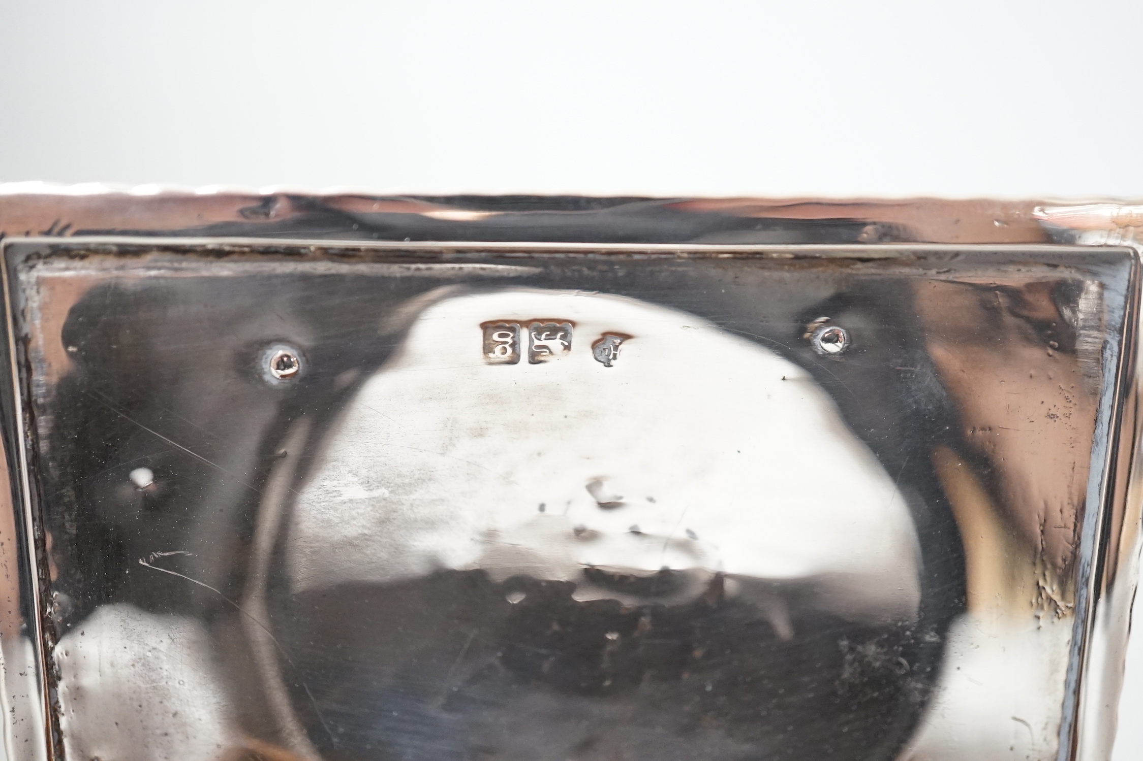 An Edwardian Arts & Crafts Kate Harris for William Hutton & Sons rectangular silver box, of lidded casket form, with relief cast foliate bracket feet, strap hinges and cedar lined interior, London, 1902, width 10.2cm, gr
